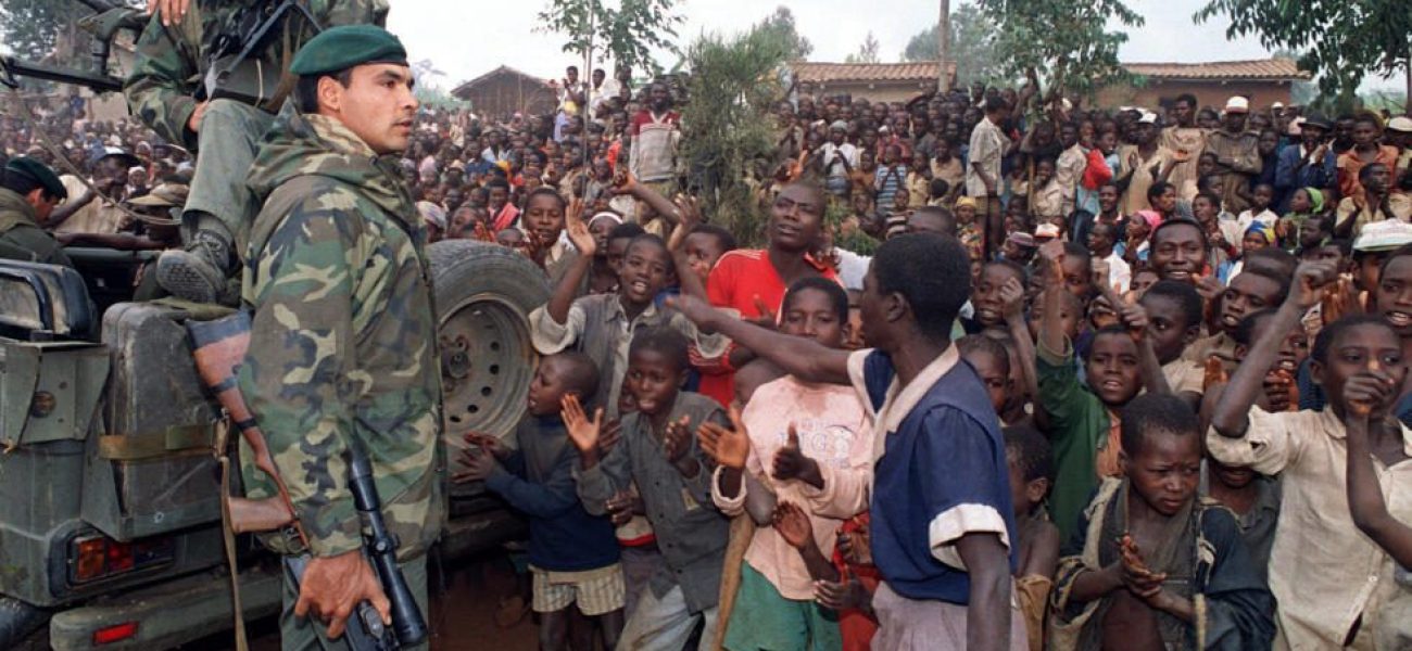 Hutu refugees greet French marines arriving in a camp four kilometers outside Butare 03 July 1994 as Rwandan rebels clashed with French forces on the outskirts of the city for the first time in the 10-days-old Operation Turquoise.