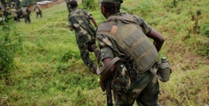 Soldiers from the Armed Forces of the Democratic Republic of the Congo (FARDC) regroup at an army outpost on a hill between the village of Kachiru and Mbuzi hill -- an M23 rebel position -- in North Kivu on May 24, 2012. The FARDC has been engaged in battles with M23 rebels who hold the Mbuzi hill, but have seen a relative calm since the night of May 22, taking the opportunity to reinforce their positions. AFP PHOTO/PHIL MOORE