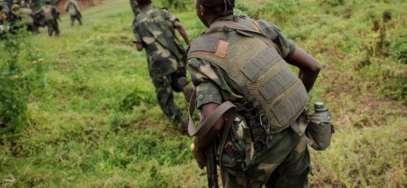 Soldiers from the Armed Forces of the Democratic Republic of the Congo (FARDC) regroup at an army outpost on a hill between the village of Kachiru and Mbuzi hill -- an M23 rebel position -- in North Kivu on May 24, 2012. The FARDC has been engaged in battles with M23 rebels who hold the Mbuzi hill, but have seen a relative calm since the night of May 22, taking the opportunity to reinforce their positions. AFP PHOTO/PHIL MOORE