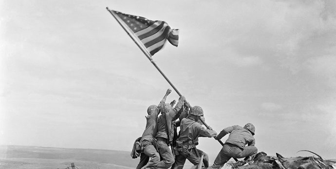 FILE - In this Feb 23, 1945 file photo, U.S. Marines of the 28th Regiment, 5th Division, raise the American flag atop Mt. Suribachi, Iwo Jima, Japan. On Monday, Oct. 9, 2017, which would have been Joe Rosenthal's 106th birthday, a group will deliver their petition with over 2,000 signatures and a letter requesting a future USS Joe Rosenthal to Secretary of the Navy Richard V. Spencer, who is responsible for naming ships. (AP Photo/Joe Rosenthal)