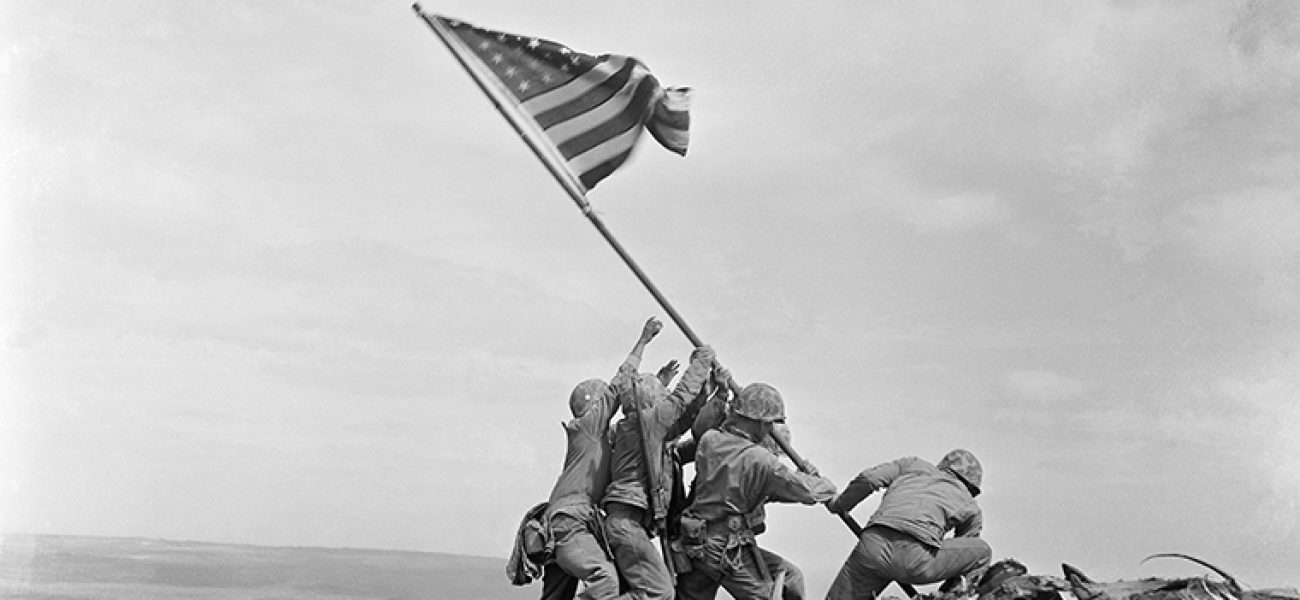 FILE - In this Feb 23, 1945 file photo, U.S. Marines of the 28th Regiment, 5th Division, raise the American flag atop Mt. Suribachi, Iwo Jima, Japan. On Monday, Oct. 9, 2017, which would have been Joe Rosenthal's 106th birthday, a group will deliver their petition with over 2,000 signatures and a letter requesting a future USS Joe Rosenthal to Secretary of the Navy Richard V. Spencer, who is responsible for naming ships. (AP Photo/Joe Rosenthal)