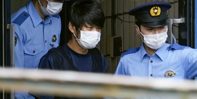 Tetsuya Yamagami, Suspected of killing former Japanese premier Shinzo Abe, is escorted by police officers as he is taken to prosecutors, at Nara-nishi police station in Nara, western Japan, in this photo taken by Kyodo July 10, 2022. Mandatory credit Kyodo via REUTERS ATTENTION EDITORS - THIS IMAGE WAS PROVIDED BY A THIRD PARTY. MANDATORY CREDIT. JAPAN OUT. NO COMMERCIAL OR EDITORIAL SALES IN JAPAN.