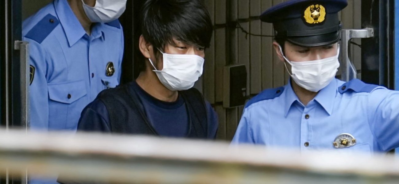 Tetsuya Yamagami, Suspected of killing former Japanese premier Shinzo Abe, is escorted by police officers as he is taken to prosecutors, at Nara-nishi police station in Nara, western Japan, in this photo taken by Kyodo July 10, 2022. Mandatory credit Kyodo via REUTERS ATTENTION EDITORS - THIS IMAGE WAS PROVIDED BY A THIRD PARTY. MANDATORY CREDIT. JAPAN OUT. NO COMMERCIAL OR EDITORIAL SALES IN JAPAN.