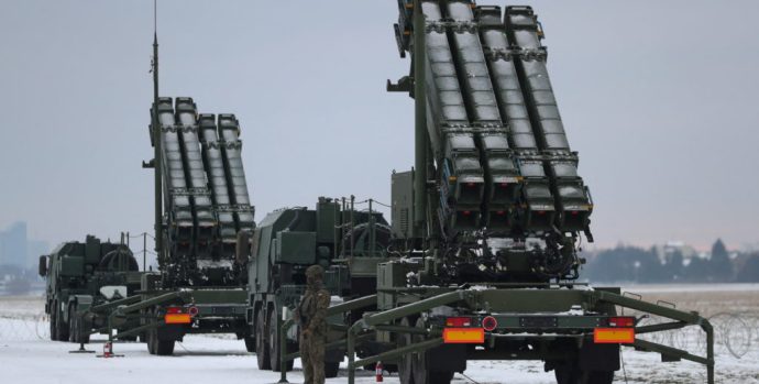 Serviceman patrols in front of the Patriot air defence system during Polish military training on the missile systems at the airport in Warsaw, Poland February 7, 2023. REUTERS/Kacper Pempel