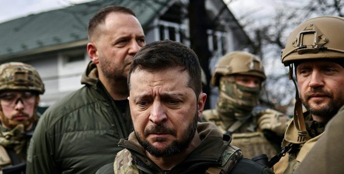 Ukainian President Volodymyr Zelensky (C) speaks to the press in the town of Bucha, northwest of the Ukrainian capital Kyiv, on April 4, 2022. Ukraine's President Volodymyr Zelensky said on April 3, 2022 the Russian leadership was responsible for civilian killings in Bucha, outside Kyiv, where bodies were found lying in the street after the town was retaken by the Ukrainian army. (Photo by RONALDO SCHEMIDT / AFP) (Photo by RONALDO SCHEMIDT/AFP via Getty Images)