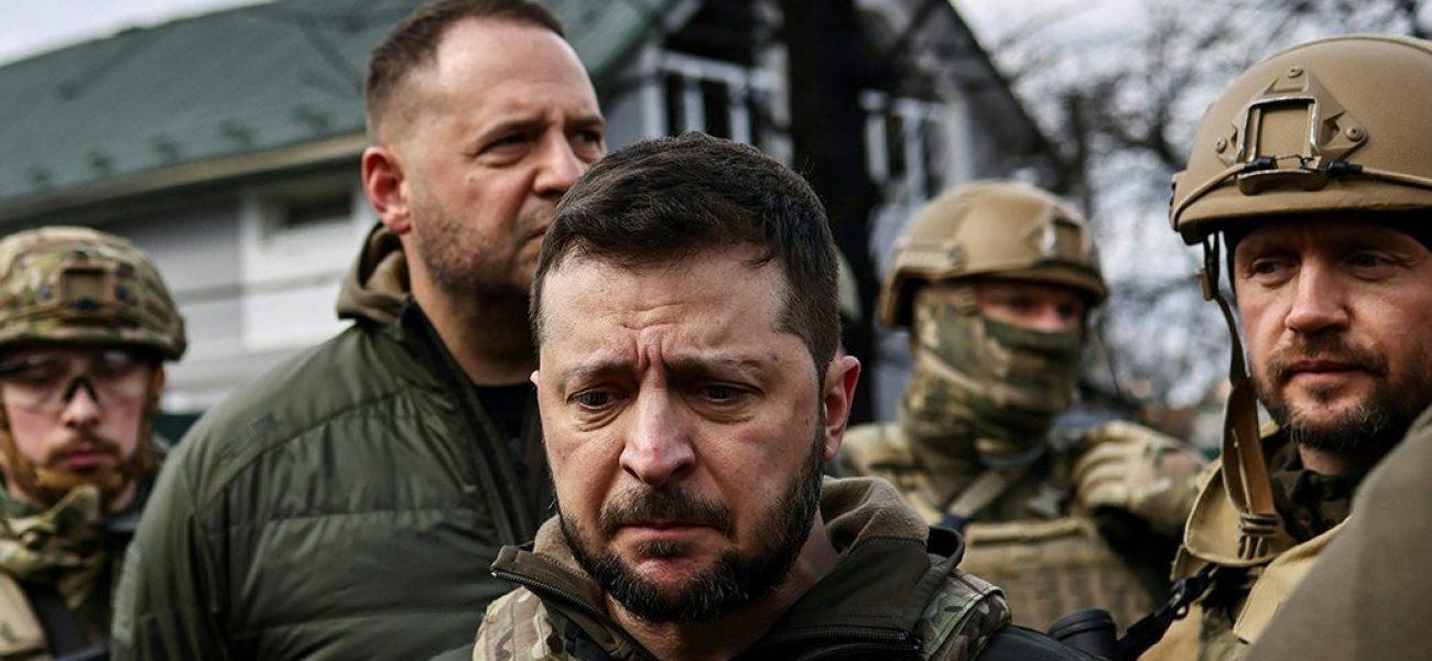 Ukainian President Volodymyr Zelensky (C) speaks to the press in the town of Bucha, northwest of the Ukrainian capital Kyiv, on April 4, 2022. Ukraine's President Volodymyr Zelensky said on April 3, 2022 the Russian leadership was responsible for civilian killings in Bucha, outside Kyiv, where bodies were found lying in the street after the town was retaken by the Ukrainian army. (Photo by RONALDO SCHEMIDT / AFP) (Photo by RONALDO SCHEMIDT/AFP via Getty Images)