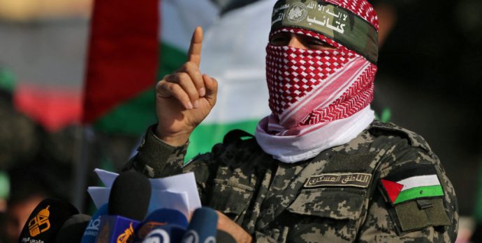 FILE PHOTO: Abu Ubaida, the spokesman of the Izz el-Deen al-Qassam Brigades, gestures as he speaks during an anti-Israel military show in the southern Gaza Strip