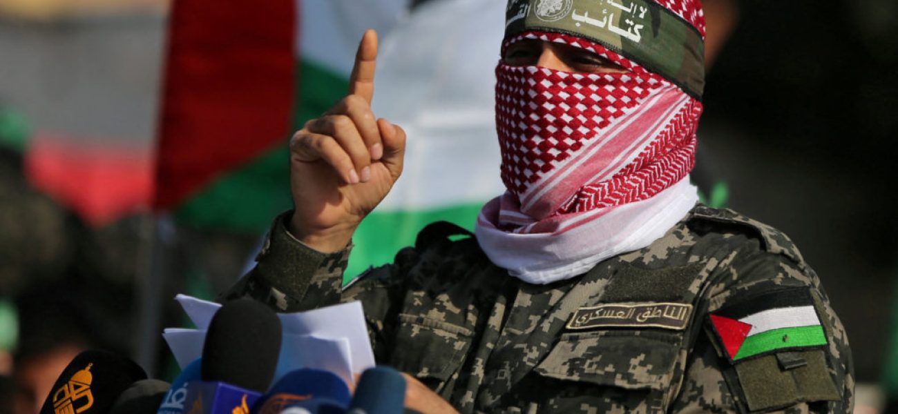 FILE PHOTO: Abu Ubaida, the spokesman of the Izz el-Deen al-Qassam Brigades, gestures as he speaks during an anti-Israel military show in the southern Gaza Strip