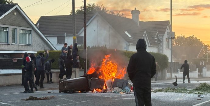 A fire burns in bins as anti-immigrant protesters clash with police at Antrim road, following a knife attack on June 8, which left a man seriously injured and prompted police to declare a critical incident, in Belfast, Northern Ireland, June 10, 2026. (OSV News photo/Isabel Infantes, Reuters)