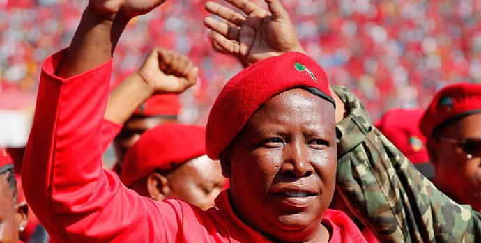 PRETORIA, SOUTH AFRICA - MAY 04:  Commander and chief of the Economic Freedom Fighters and South African presidential candidate Julius Malema greets supporters as he enters the Lucas Moripe Stadium for an Economic Freedom Fighters presidential campaign rally at the Lucas Moripe Stadium on May 4, 2014 in Pretoria, South Africa. The rally comes prior to the South African presidential elections which are scheduled to be held on May 7, 2014. (J. Countess/Getty Images)
