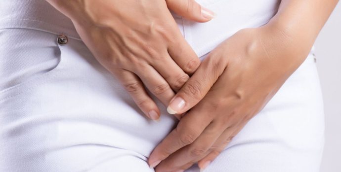 8_Midsection-Of-Woman-Hands-Over-Vagina-While-Standing-Against-White-Background_1
