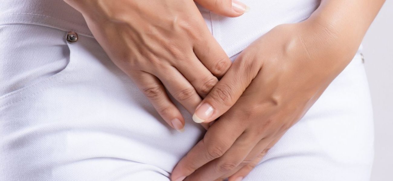 8_Midsection-Of-Woman-Hands-Over-Vagina-While-Standing-Against-White-Background_1