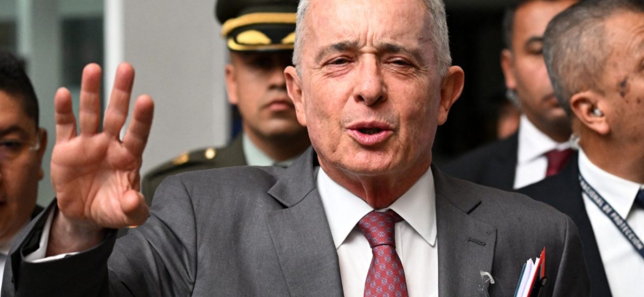 (FILES) Colombian former President Alvaro Uribe gestures as he speaks to the press outside a court complex at the end of his trial in Bogota on February 10, 2025. A Colombian court on August 1, 2025, sentenced still-powerful former president Alvaro Uribe to 12 years of house arrest after he was found guilty of witness tampering, a legal source told AFP. The sentence, which is due to be publicly announced later on Friday, marks the first time in Colombia's history that a former president has been convicted of a crime and sentenced. Uribe, now 73-years old, insists he is innocent and is expected to appeal the ruling. (Photo by Raul ARBOLEDA / AFP)