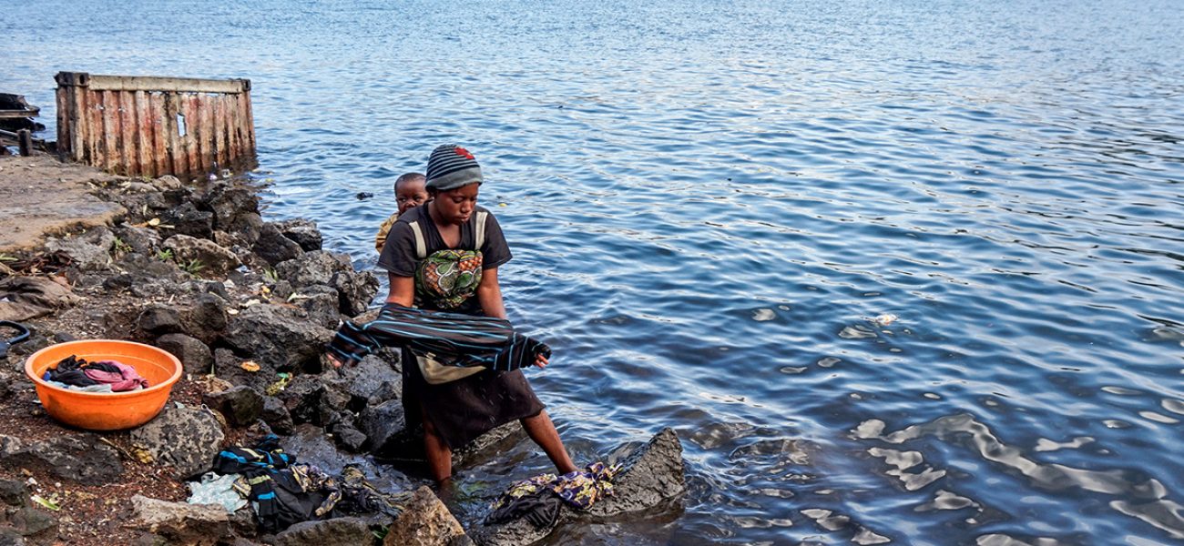 Catherine Mutokambali, of Himbi, a neighborhood in Goma, Democratic Republic of Congo, washes her clothes on the shore of Lake Kivu. According to Mutokambali, XX water shortages at her home have caused her to wake up at 5 a.m. every morning to wash her laundry. (Nadia Kanyere Karasisi, GPJ Democratic Republic of Congo)