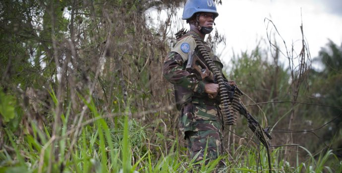A member of FIB stands in the bush near the front line in the Beni region where the UN is backing the FARDC in an operation against ADF militia, the 13th of March 2014.   © MONUSCO/Sylvain Liechti