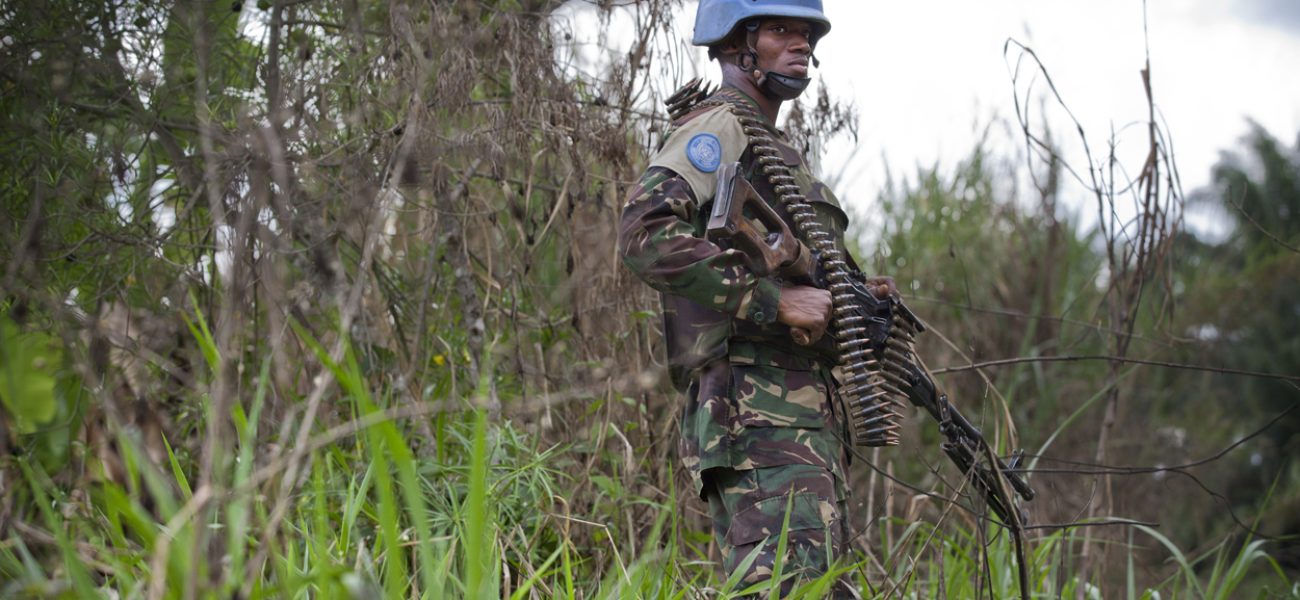 A member of FIB stands in the bush near the front line in the Beni region where the UN is backing the FARDC in an operation against ADF militia, the 13th of March 2014.   © MONUSCO/Sylvain Liechti