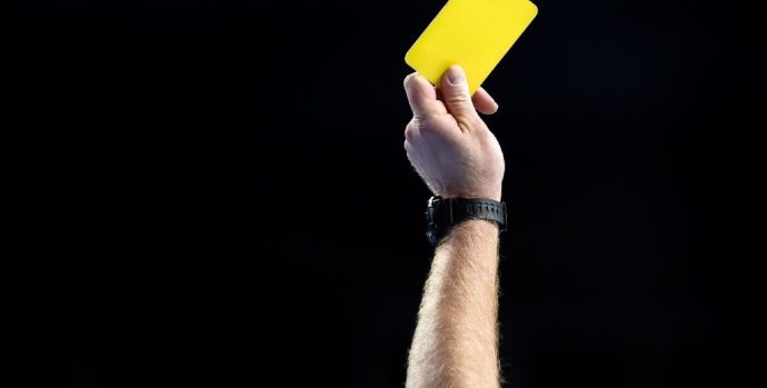 Referee-shows-yellow-card-1140x570