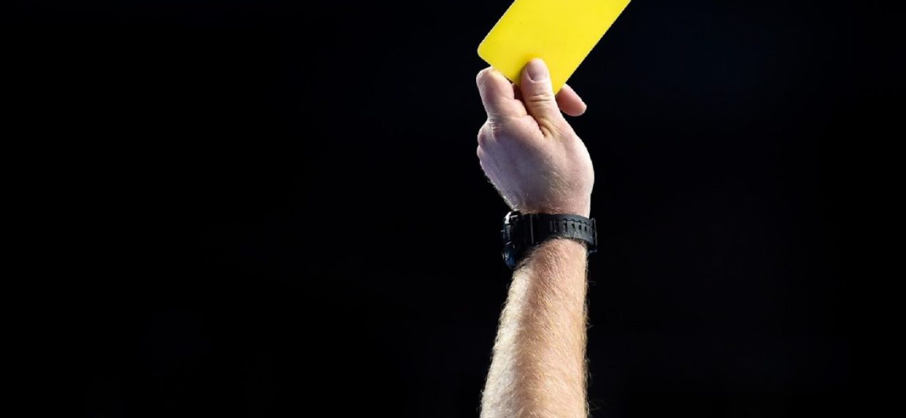 Referee-shows-yellow-card-1140x570