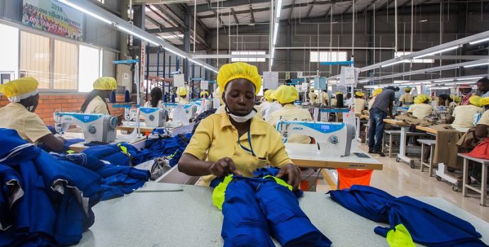 KIGALI, RWANDA - MAY 18, 2018: Employees at a Chinese-owned factory on the outskirts of Rwanda's capital, Kigali, prepare polyester polo shirts ahead of an increase in tariffs that will make Rwandan-made clothes costlier for U.S. distributors.