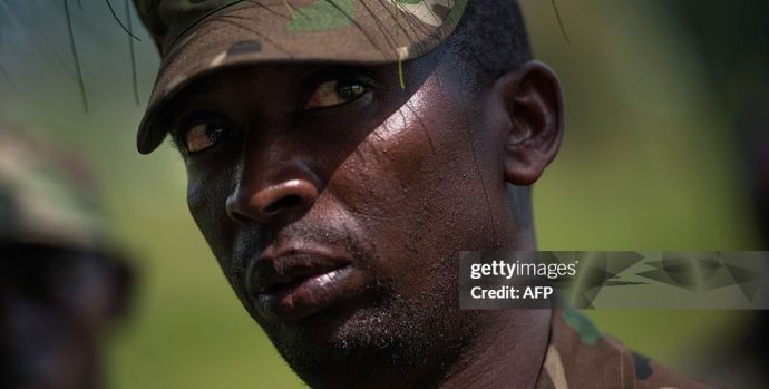 Colonel Innocent Kaina, a sector commander for M23 rebels on the front-lines near Goma, stands at a rebel position during an interview with journalists, near Goma, on the outskirts of the eastern Democratic Republic of Congo city on November 19, 2012. DR Congo's M23 rebels who have closed in on the main eastern city of Goma warned that they will continue their fight against the government unless it opens direct talks with them within 24 hours. The rebels said in a statement they will "pursue the resistance against the government of Kinshasa until it falls" unless it starts "direct political negotiations" with the insurgents within the next 24 hours and demilitarises Goma and the city's airport. AFP PHOTO/PHIL MOORE        (Photo credit should read PHIL MOORE/AFP via Getty Images)