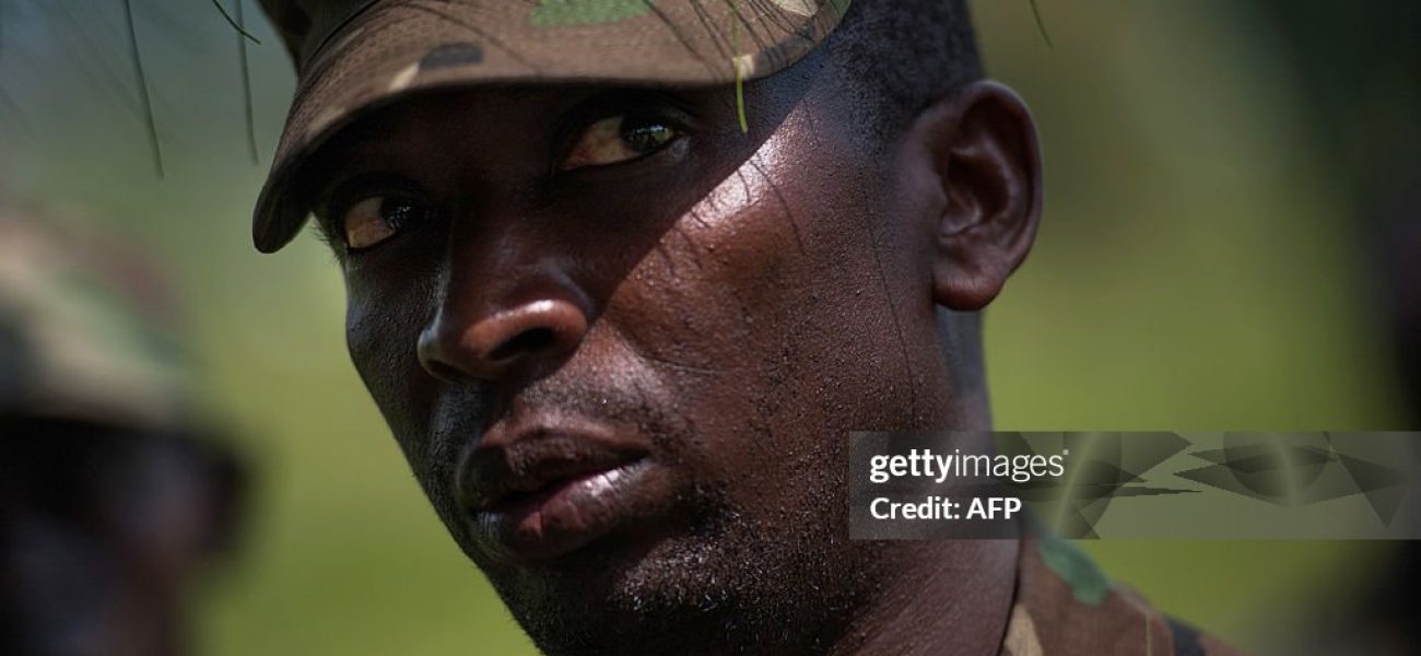 Colonel Innocent Kaina, a sector commander for M23 rebels on the front-lines near Goma, stands at a rebel position during an interview with journalists, near Goma, on the outskirts of the eastern Democratic Republic of Congo city on November 19, 2012. DR Congo's M23 rebels who have closed in on the main eastern city of Goma warned that they will continue their fight against the government unless it opens direct talks with them within 24 hours. The rebels said in a statement they will "pursue the resistance against the government of Kinshasa until it falls" unless it starts "direct political negotiations" with the insurgents within the next 24 hours and demilitarises Goma and the city's airport. AFP PHOTO/PHIL MOORE        (Photo credit should read PHIL MOORE/AFP via Getty Images)