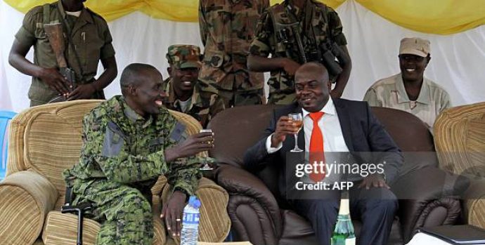 M23 rebel military wing leader Brigdier Generl Sultan Makenga (L) and newly elected M23 Rebel political wing President, Bertrand Bisimwa (R) toast in Bunagana on March 7, 2013. The rebel group has parted ways with their former President Bishop Jean-Marie Runiga after allegations of misuse of funds and supporting Bosco Ntaganda, a wanted war criminal. AFP PHOTO/ ISAAC KASAMANI        (Photo credit should read ISAAC KASAMANI/AFP via Getty Images)