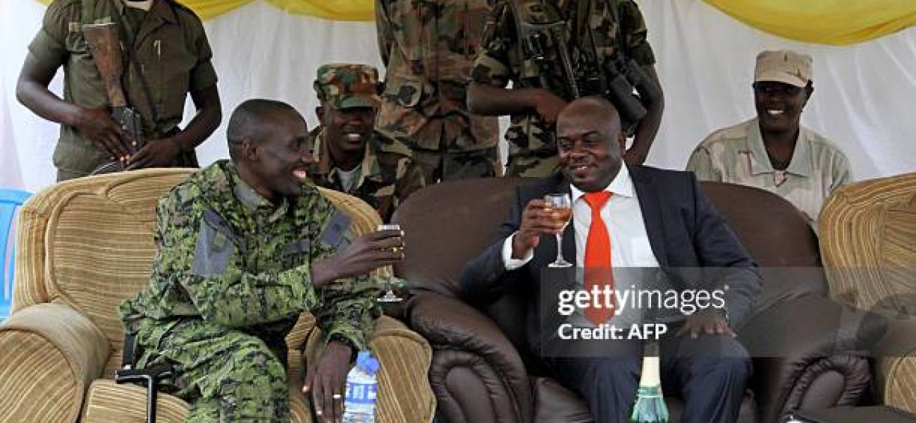 M23 rebel military wing leader Brigdier Generl Sultan Makenga (L) and newly elected M23 Rebel political wing President, Bertrand Bisimwa (R) toast in Bunagana on March 7, 2013. The rebel group has parted ways with their former President Bishop Jean-Marie Runiga after allegations of misuse of funds and supporting Bosco Ntaganda, a wanted war criminal. AFP PHOTO/ ISAAC KASAMANI        (Photo credit should read ISAAC KASAMANI/AFP via Getty Images)