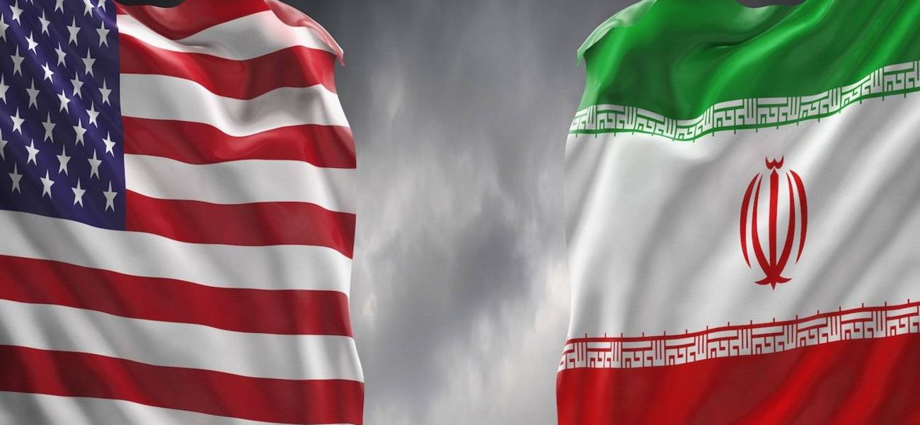 u-s-and-iranian-flags-wave-against-a-dark-cloudy-sky